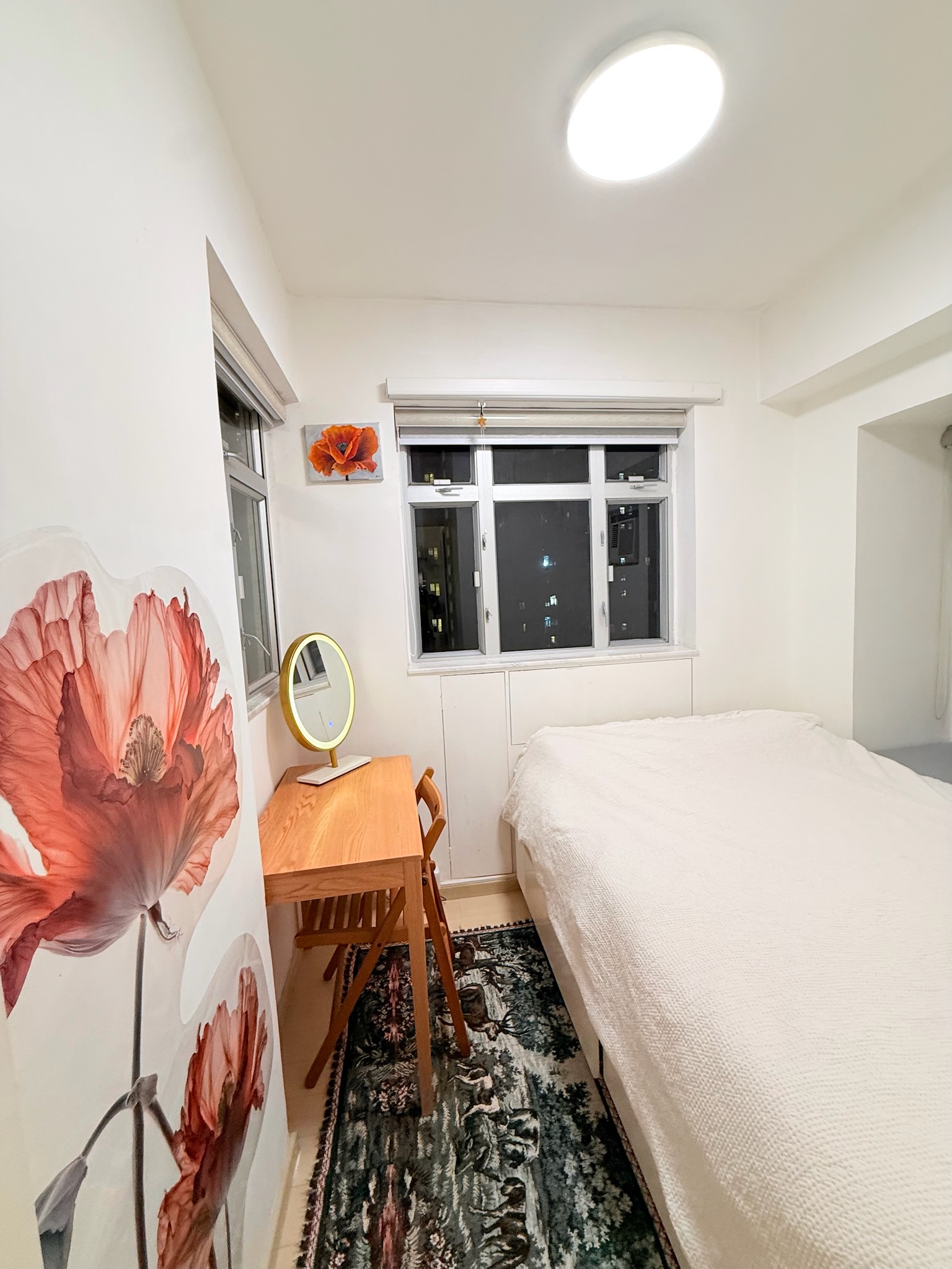 Bedroom with desk and floral wall art