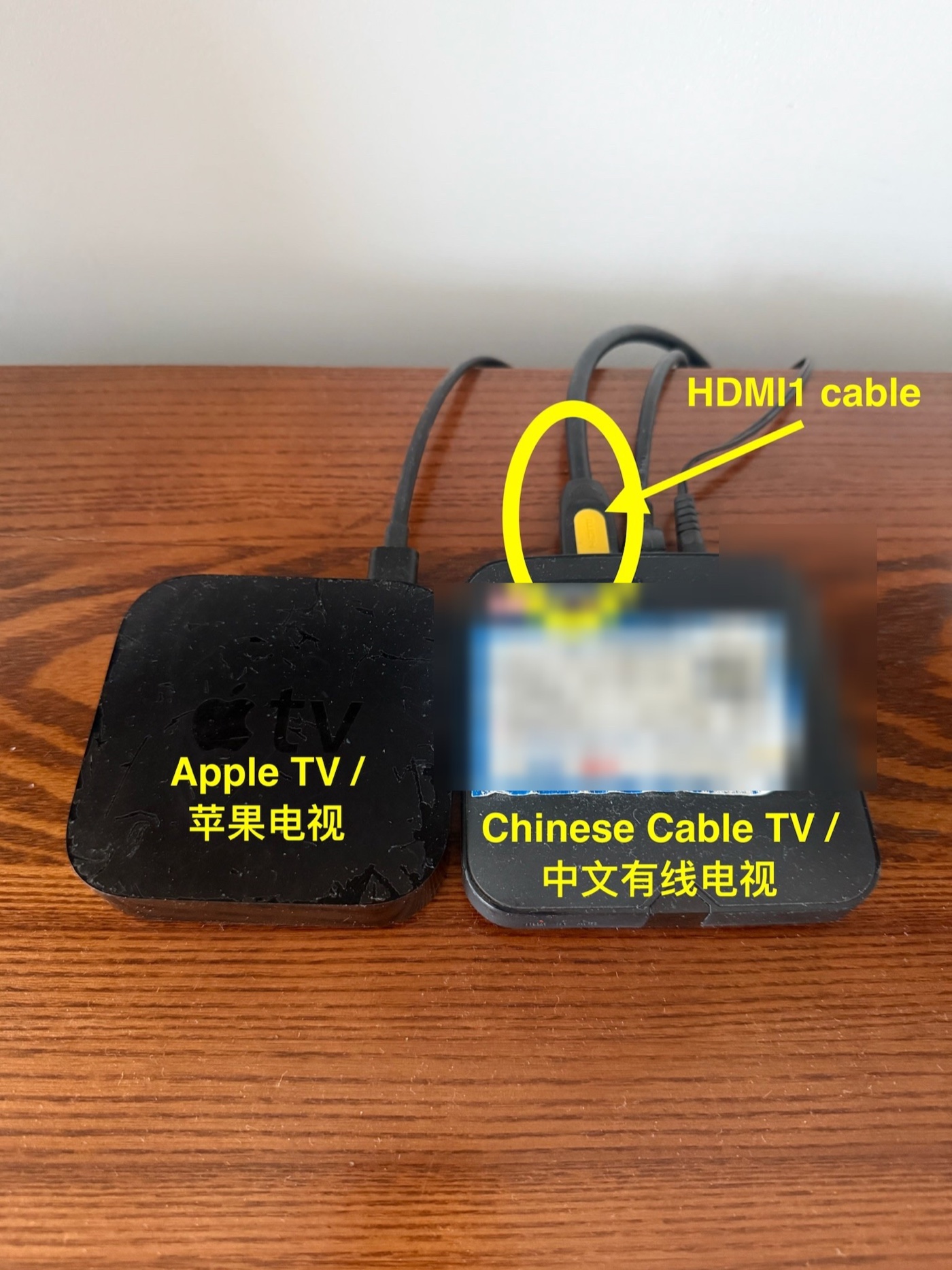 Apple TV and cable TV boxes with the black and yellow HDMI cable highlighted