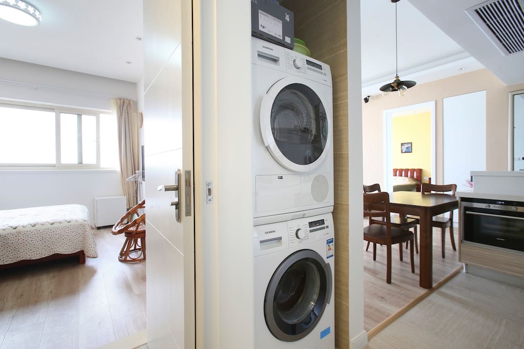 In-unit washer and dryer between the bedrooms and dining area