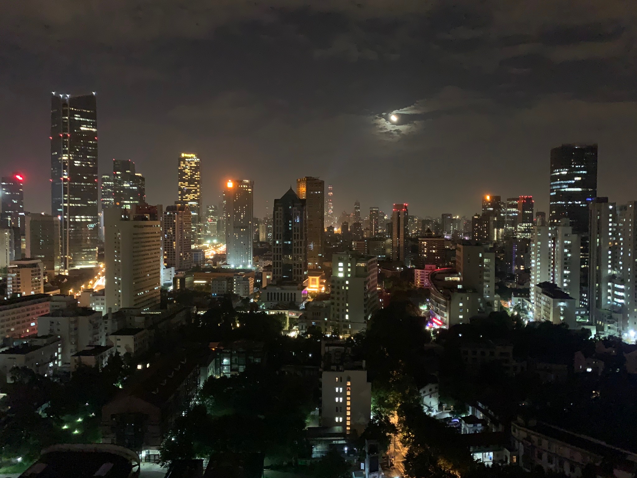 Shanghai skyline and moon at night